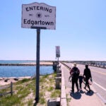 A family walks to the span of the American Legion Memorial Bridge, also known as the "Jaws Bridge."