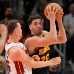 Atlanta Hawks forward Georges Niang (20) looks to pass in the second half of an NBA play-in tournament basketball game against the Miami Heat, Friday, April 18, 2025, in Atlanta.