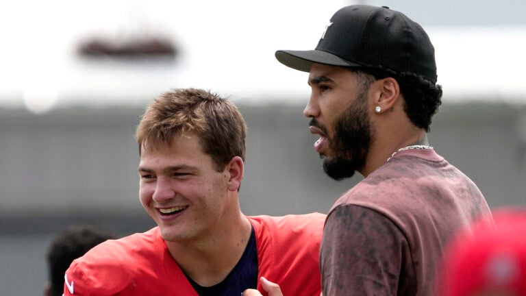 New England Patriots quarterback Drake Maye (10) greets Boston Celtic star Jayson Tatum after today’s joint training camp practice with the Washington Commanders in Foxborough, MA.